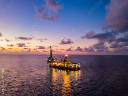Aerial View of Tender Drilling Oil Rig (Barge Oil Rig) in The Middle of The Ocean at Sunset Time