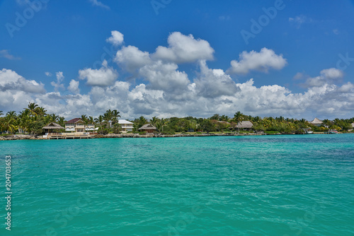 Tropical villas and bungalows as seen from the turquoise ocean typical Caribbean Island life