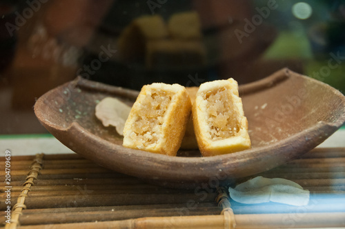 Traditional sweet Taiwanese pineapple dried cake with full of fillings and thin shell, served in a wooden bowl