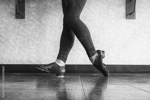 Black and white version of Toe Heel stand in tap shoes during dance class