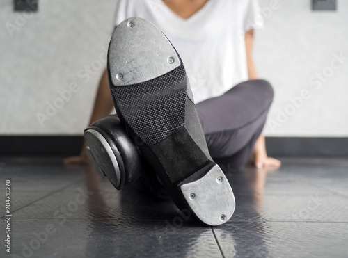 Crossed legs tap dancer and her shoes photo