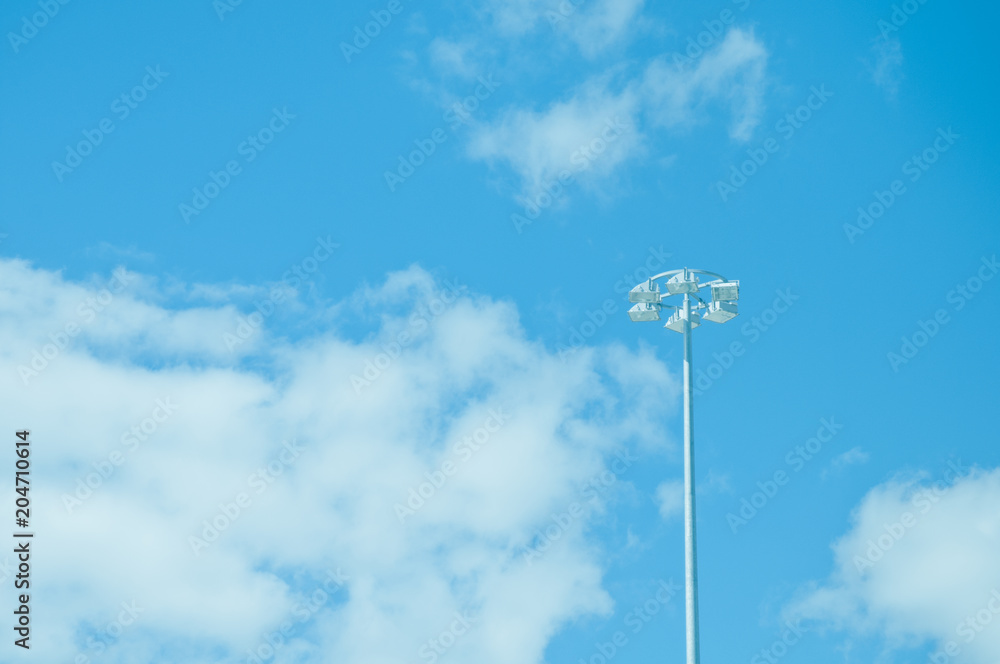 Spotlight pole and blue clear sky