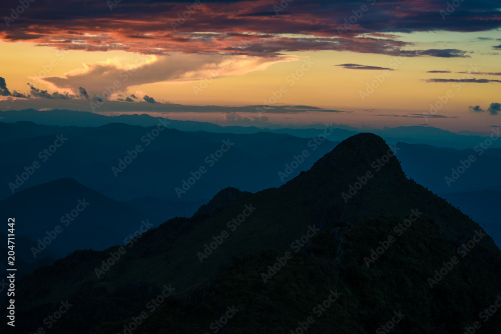 Sunset on peak of mountain with sky clod before rainy
