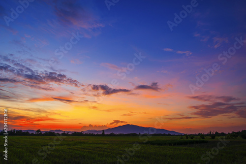 landscape of mountain and field in countryside at twilight