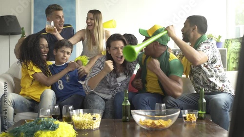 Brazilian soccer fans watching televised match at home