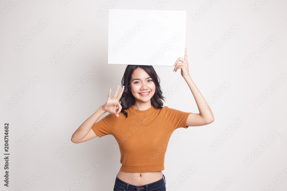 Young Asian woman show OK with white blank sign. Young Asian woman show OK with white blank sign.