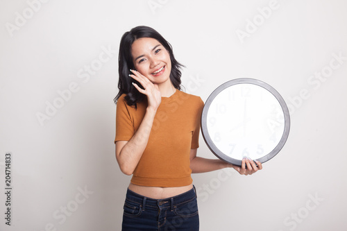 Happy Young Asian woman with a clock. © halfbottle