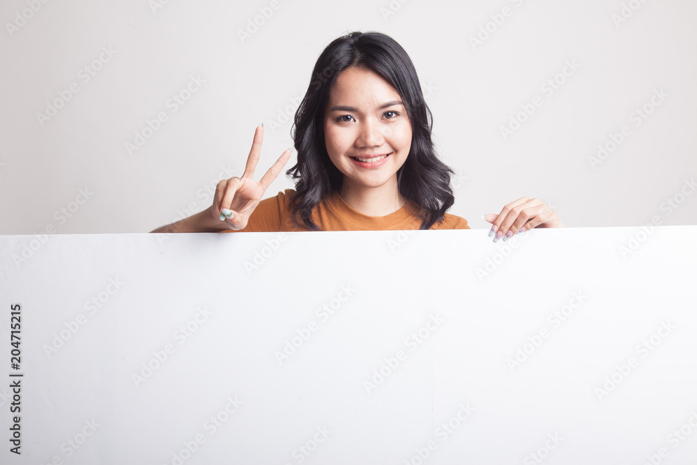 Young Asian woman show victory sign with blank sign. Young Asian woman show victory sign with blank sign.
