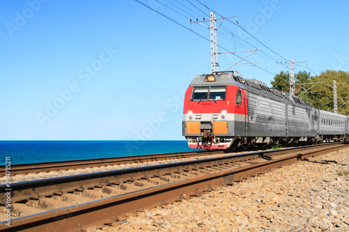 passenger train goes along the seashore