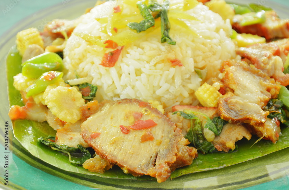 spicy stir fried sweet grilled and crispy pork with basil leaf on rice spicy stir fried sweet grilled and crispy pork with basil leaf on rice