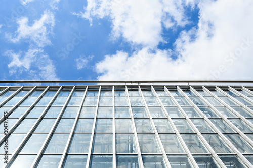 Modern Architecture high-rise building raising to the sky. Facade glass window. sky background