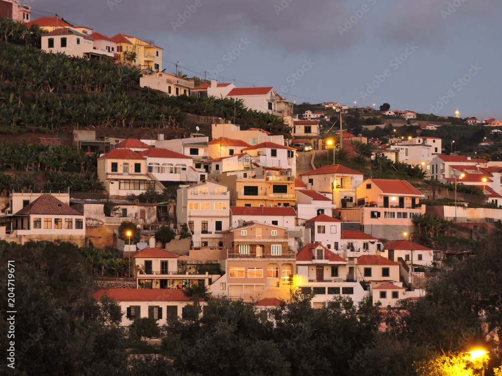Hillside houses with red roofs in the evening, Madeira