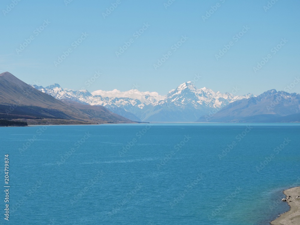 View on snow-capped mountains from stunning blue Lake Pukaki, New Zealand, Aoraki / Mount Cook View on snow-capped mountains from stunning blue Lake Pukaki, New Zealand, Aoraki / Mount Cook