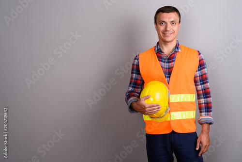 Man construction worker against gray background