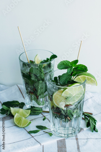 Mojito cocktail with lime and mint in glass