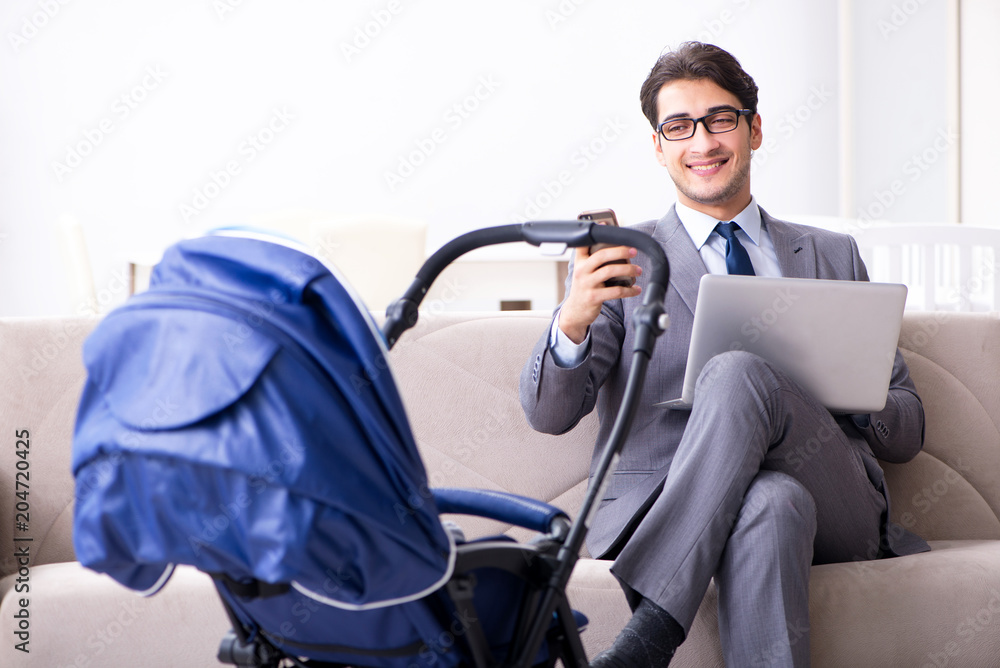 Businessman looking after newborn baby at home and teleworking Businessman looking after newborn baby at home and teleworking