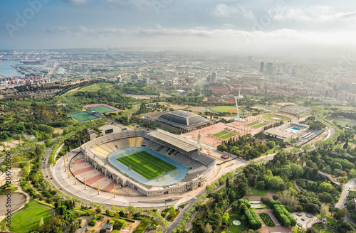 Barcelona aerial panorama, Anella Olimpica sport complex on the hill with city skyline , Spain. Late afternoon light