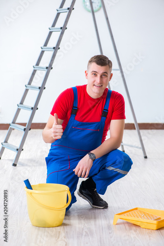 Male painter preparing for painting job at construction site