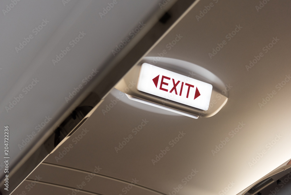 Emergency exit sign in the airplane. Emergency exit sign in the airplane.
