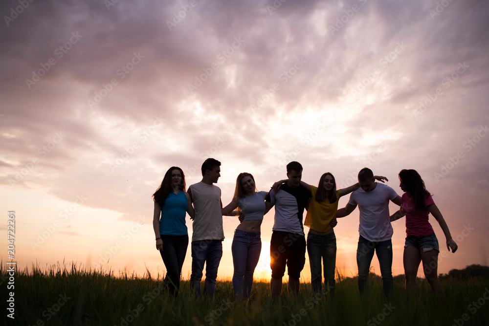 Silhouettes of people againstl sunset sky Silhouettes of people againstl sunset sky