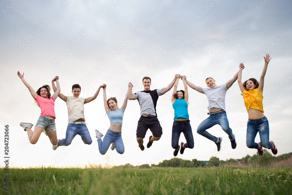 Young people jumping against the sunset sky Young people jumping against the sunset sky