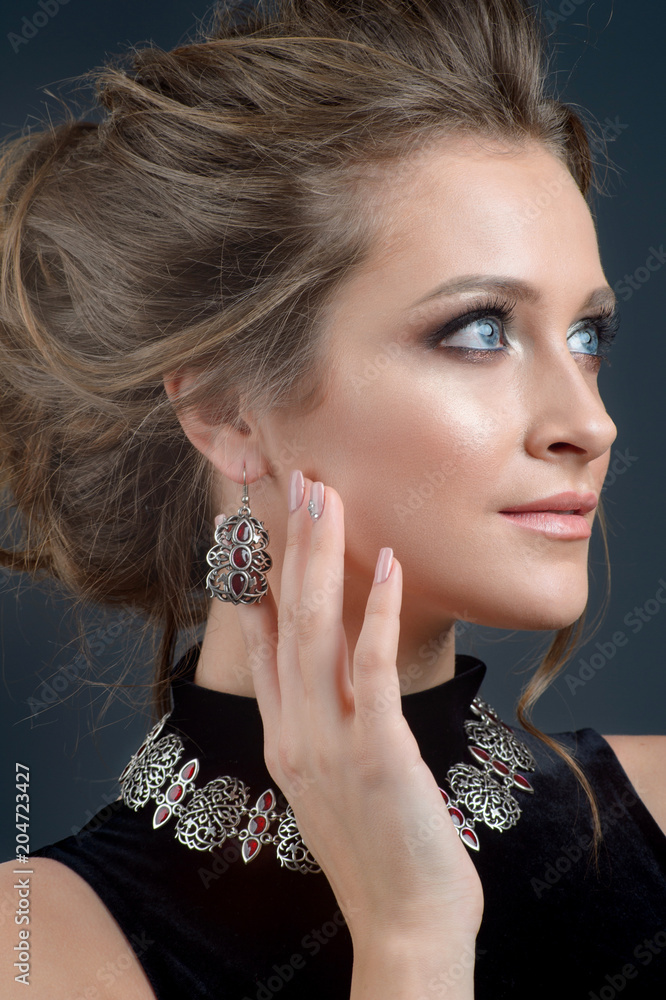 Perfect woman model wearing luxury silver accessory and jewelry.