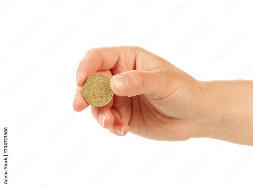 Coin one hryvnia in female hand isolated on white Coin one hryvnia in female hand isolated on white