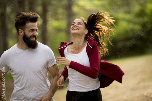 Couple jogging outdoors in ...