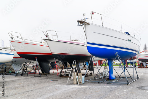Sailboats standing on land on a misty spring morning.