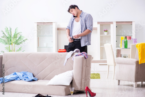 Man with mess at home after house party