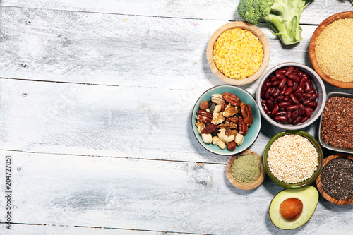 superfood concept on white table with avocado, goji and nuts and seeds.