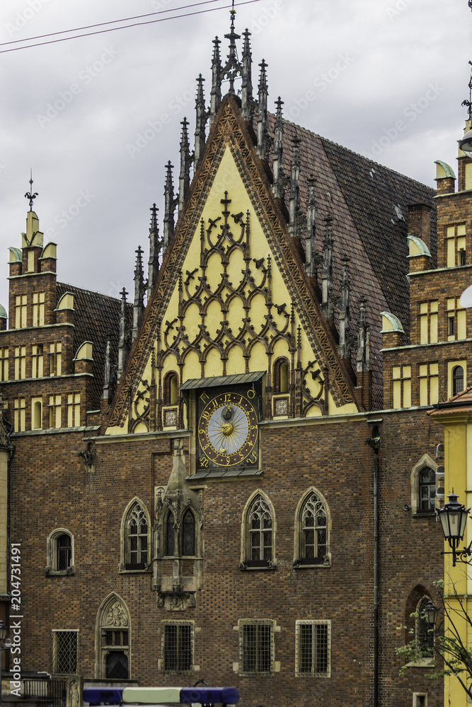 Facades, roofs , sculptures,stone decoration and towers of the medieval Town Hall. Mixed style of architecture - Gothic and Baroque. Vroslav, Poland.