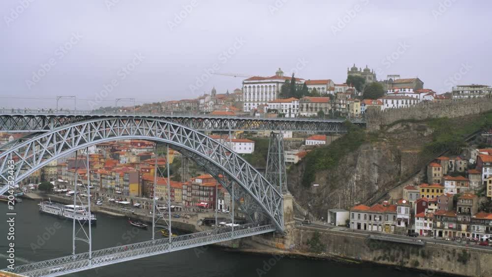 Beautiful timelapse with cars and people moving by the steel bridge Ponte Dom Luis I over the river Douro in Oporto, Portugal. Beautiful timelapse with cars and people moving by the steel bridge Ponte Dom Luis I over the river Douro in Oporto, Portugal.