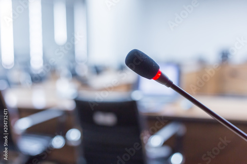 Microphone over the blurred business forum Meeting or Conference Training Learning Coaching Room Concept, Blurred background