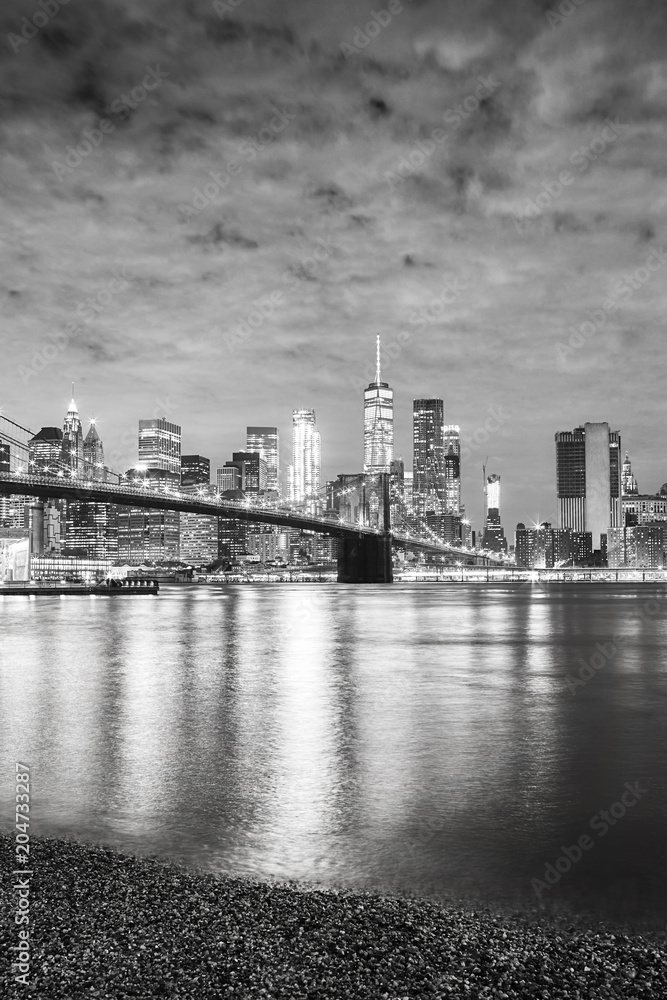 Black and white picture of Manhattan waterfront at night, New York City, USA.