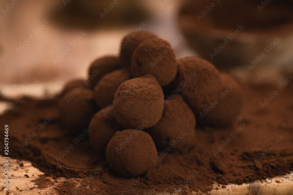 craft chocolate truffles on wooden board with cocoa powder craft chocolate truffles on wooden board with cocoa powder