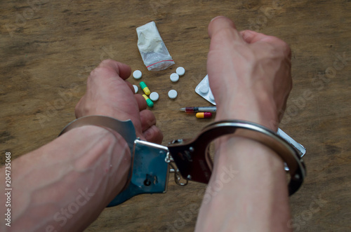 hands in handcuffs, drugs