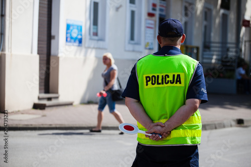 A Polish policeman regulates traffic on the street during a city run. 