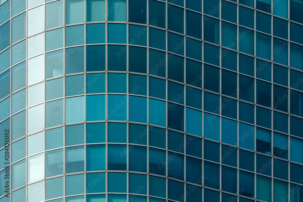 close-up of the facade of a modern multi-storey high-rise building of blue glass close-up of the facade of a modern multi-storey high-rise building of blue glass