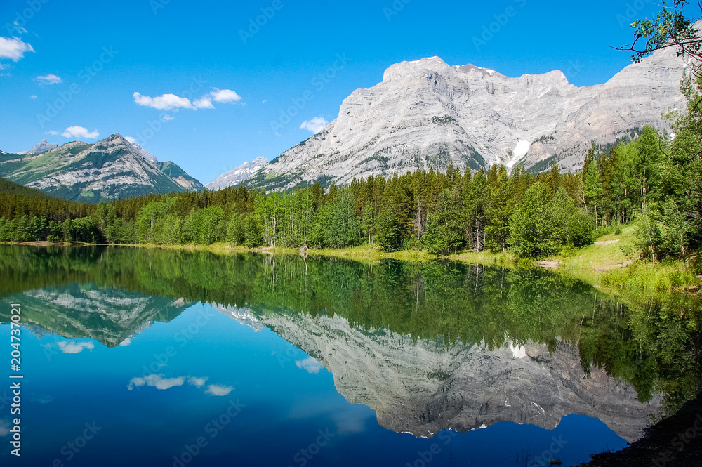 a lake with the mountain reflection on the water