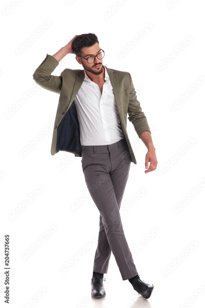 relaxed man dressed formally standing with hand behind head relaxed man dressed formally standing with hand behind head