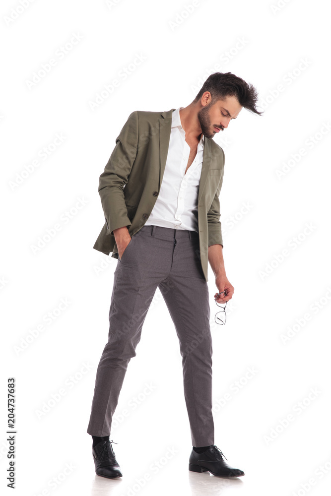 elegant man posing while looking down to side elegant man posing while looking down to side