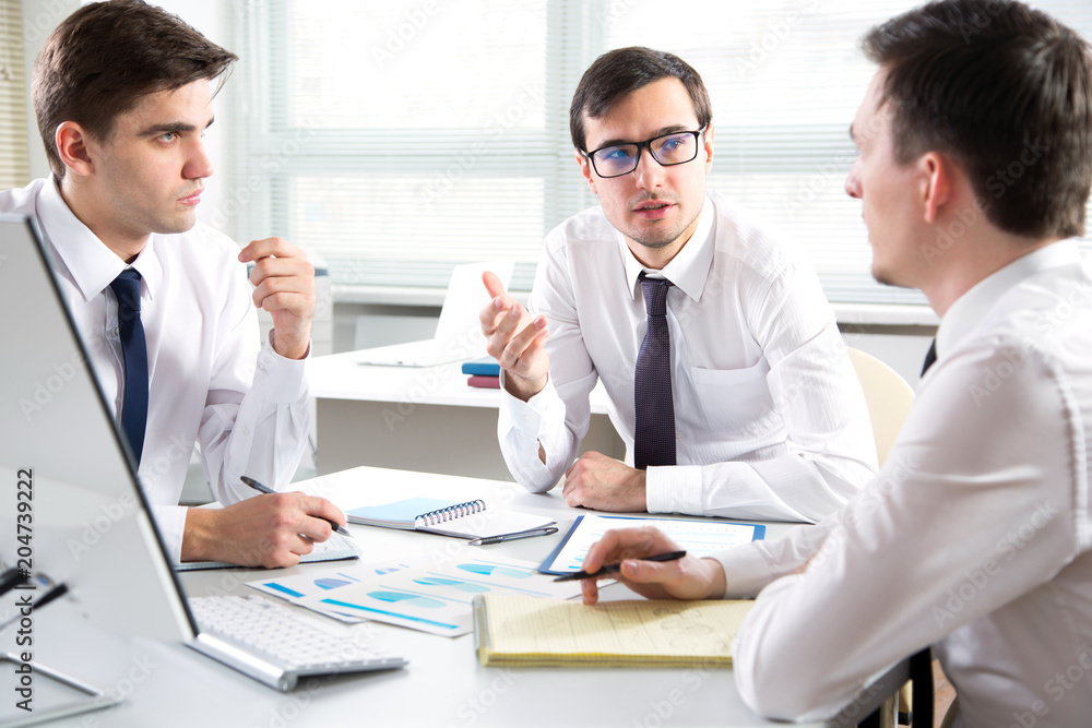 Businessmen working in an office Businessmen working in an office
