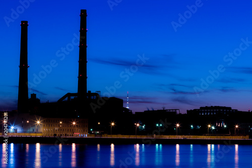 The evening thermal power station on the Neva river embankment in Saint Petersburg, Russia