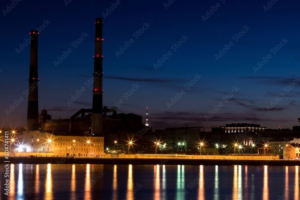 The evening thermal power station on the Neva river embankment in Saint Petersburg, Russia