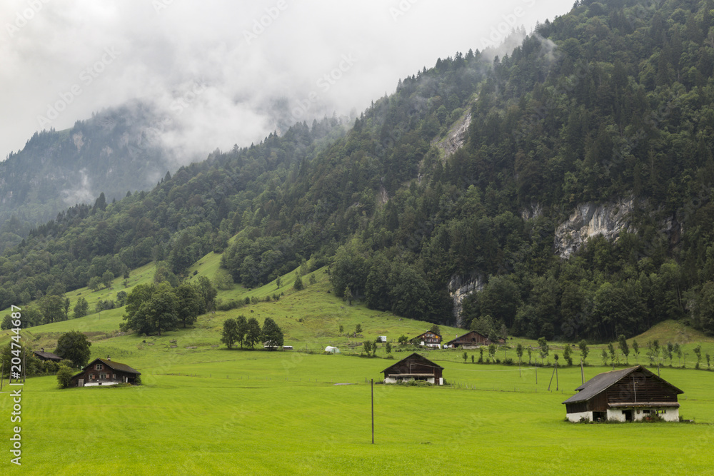 Alpine village in the fog. Swiss Alps . Switzerland. Alpine village in the fog. Swiss Alps . Switzerland.