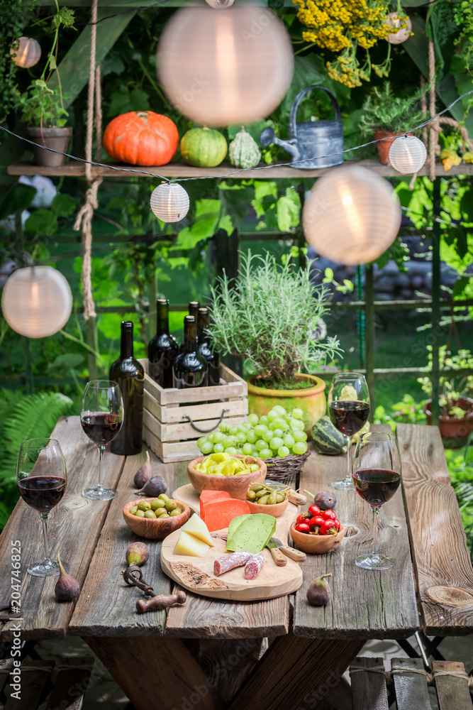 Evening in summer garden with wine and fruits