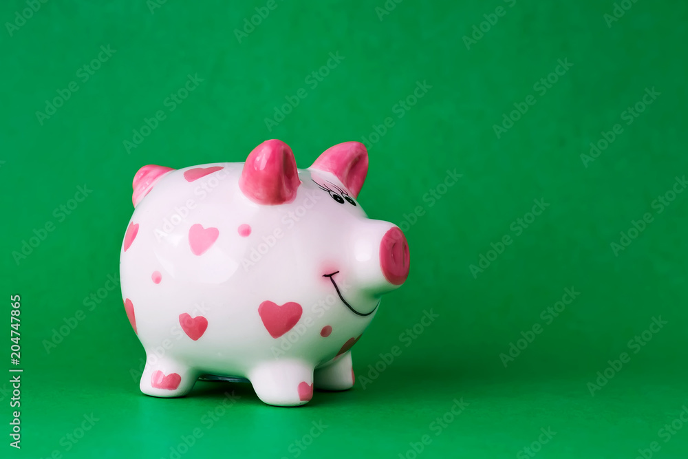 Piggy bank on green background. Copy space. Finance. Preservation. Piggy bank on green background. Copy space. Finance. Preservation.