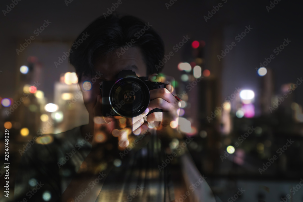a man taking photograph Bokeh light of city at night by digital camera a man taking photograph Bokeh light of city at night by digital camera