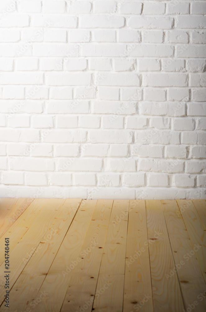 White brick wall of painted genuine clay blocks and wooden floor background